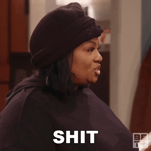 a woman wearing a black hat is making a face and says shit