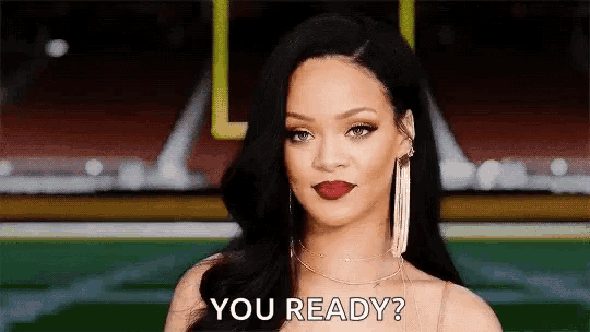 a woman with long black hair and red lipstick is asking if she is ready to go .
