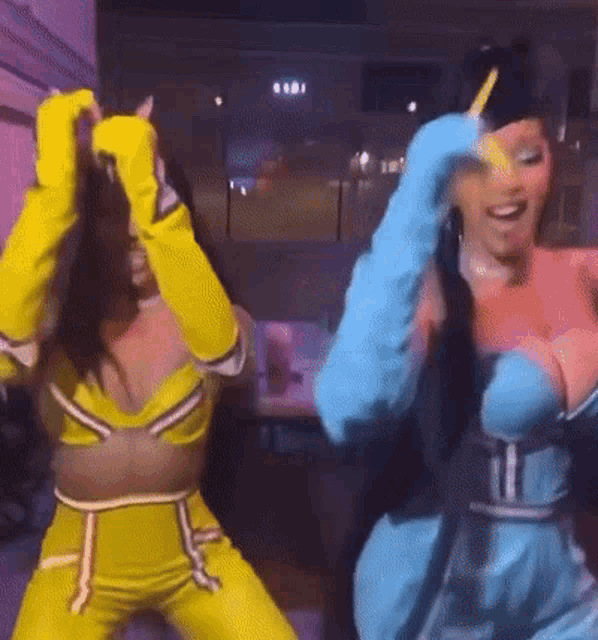 a couple of women are dancing together in a room .