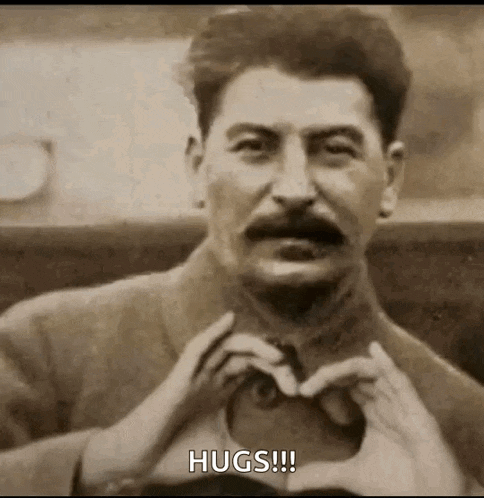 a man is making a heart shape with his hands .