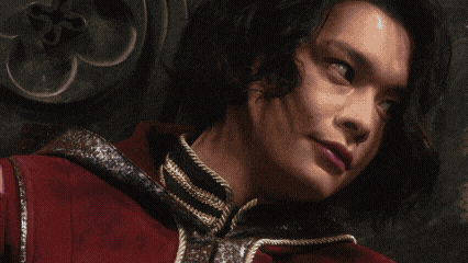 a close up of a person 's face with a red jacket