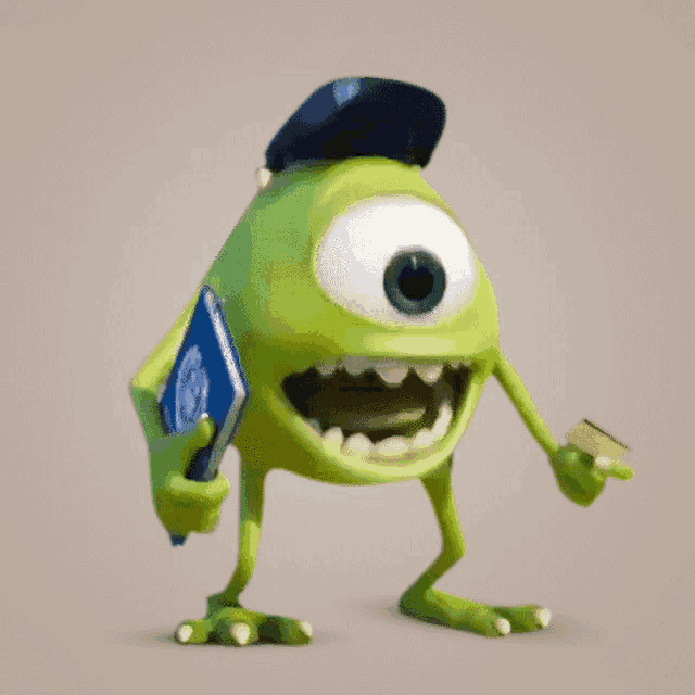 a green monster from monsters inc holding a book