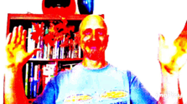 a man in a blue shirt is waving his hands