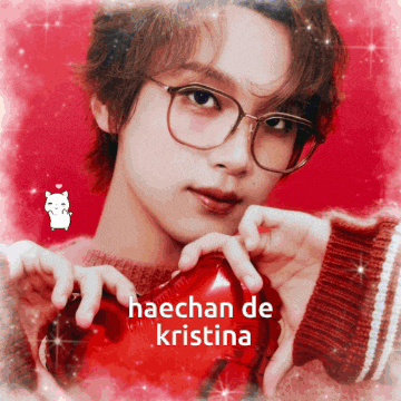 a man wearing glasses is holding a red heart and the words haechan de kristina are above him