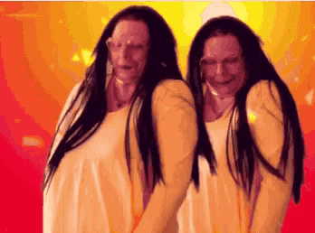 two women with long black hair are standing next to each other on a red background