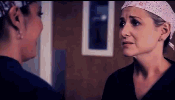 two female doctors are talking to each other in a room