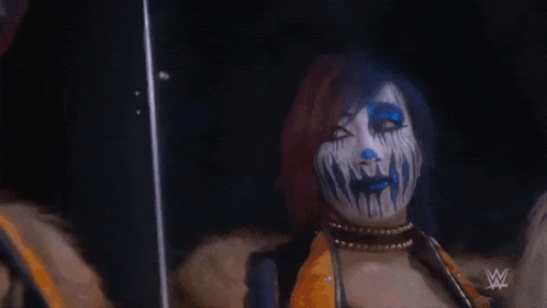 a woman with blue and white face paint is wearing a choker .