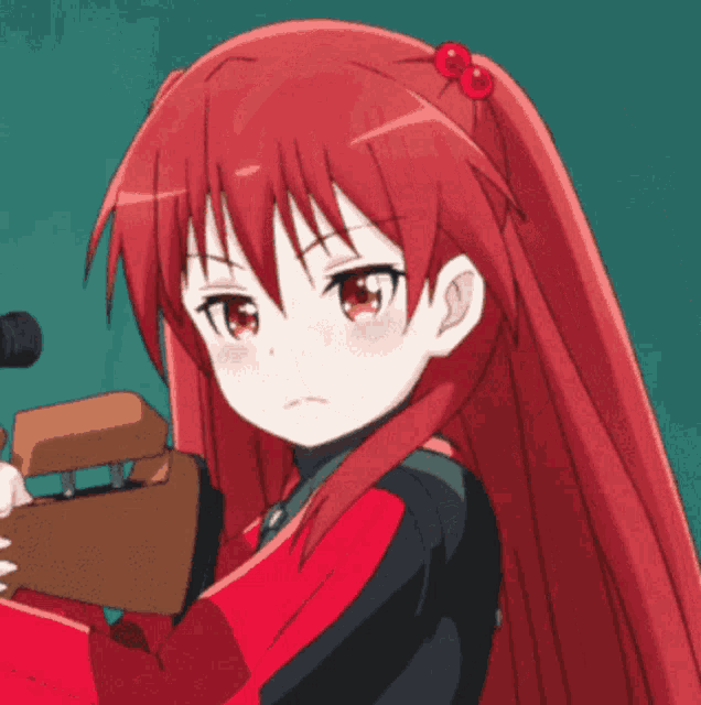 a girl with long red hair is holding a gun