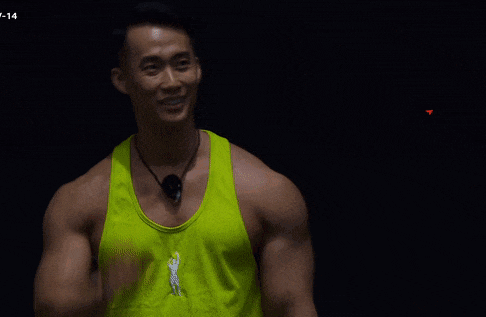a man in a neon yellow tank top is standing in front of a sign that says ' 설기관 '