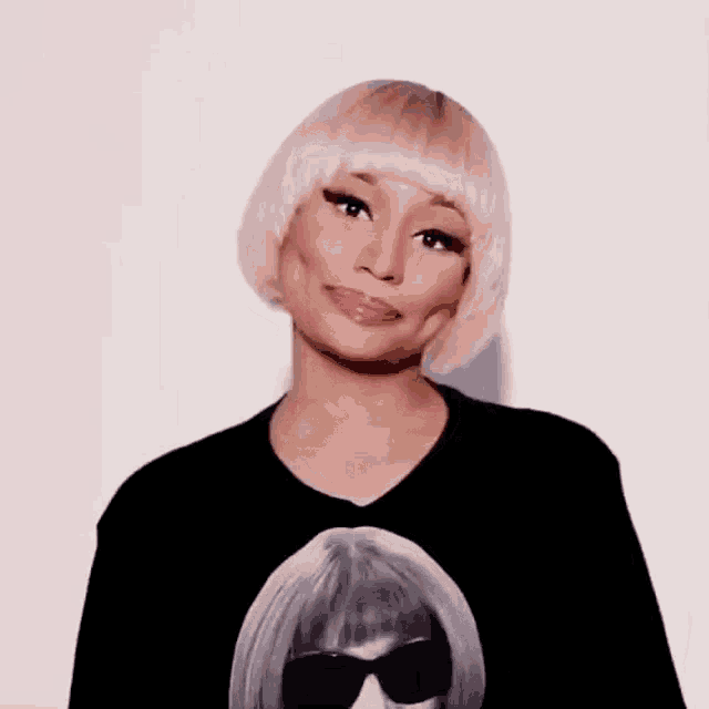 a woman wearing a black t-shirt with a picture of a woman wearing sunglasses