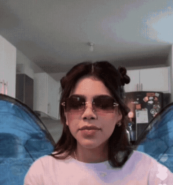 a woman wearing sunglasses has a sticker on her refrigerator that says ' simpson ' on it