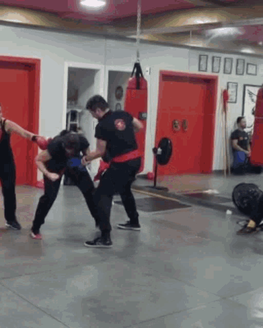a group of people are boxing in a gym