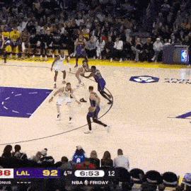 a basketball game is being played on a court with a crowd watching .