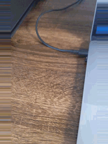 a black cord is plugged into a laptop