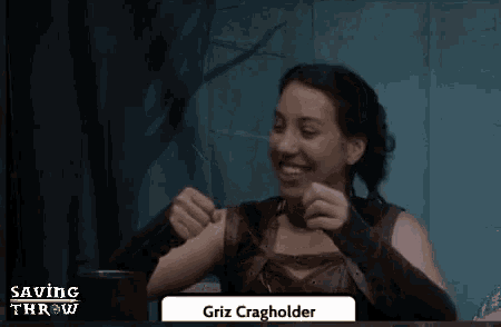 a woman is sitting at a table with a name tag that says griz cragholder