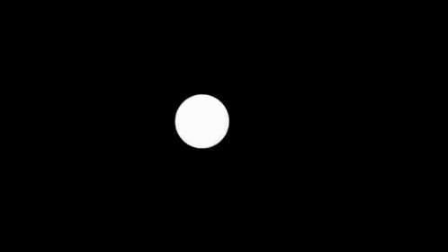 a man in a suit is walking through a circular hole