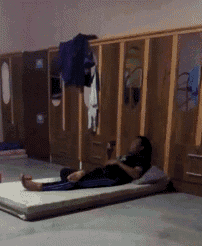 a person laying on a mat in a locker room