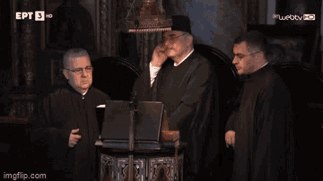three priests are standing in front of a podium with ept 5 hd written on the bottom