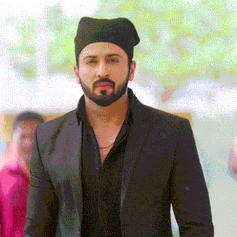 a man with a beard wearing a black hat and a suit