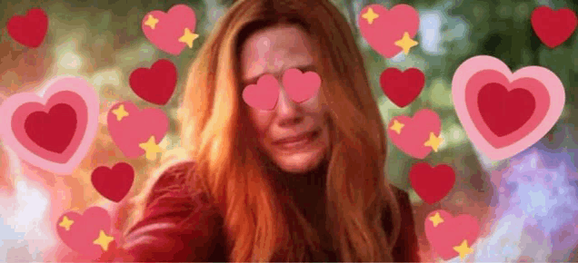 a woman with red hair is crying with hearts surrounding her .