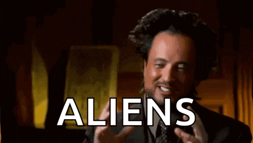 a man in a suit and tie is talking about aliens and making a funny face .