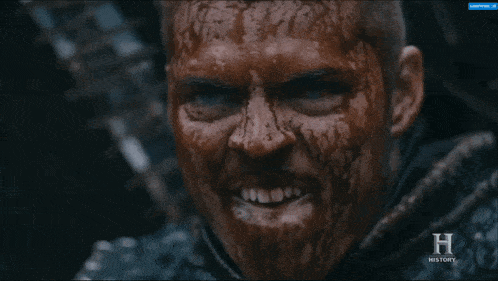 a close up of a man with blood on his face and the word history in the corner