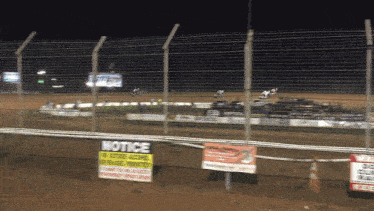 a fence with a notice sign on it