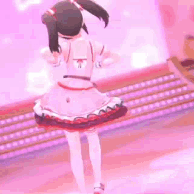 a girl is dancing on a stage in a pink dress .