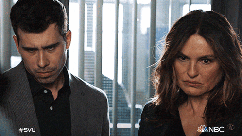 a man and a woman are standing next to each other and the nbc logo is visible