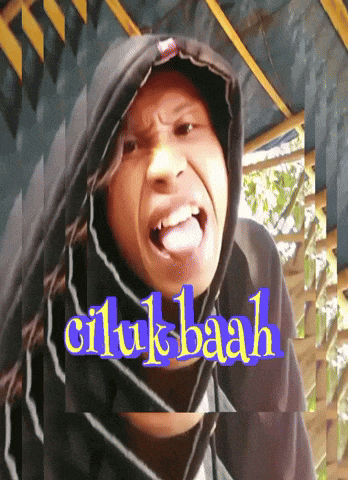 a man wearing a hooded sweatshirt with the word ciluk baah on the bottom right