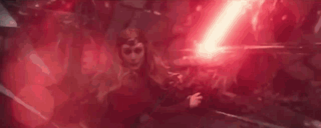 a woman is holding a red lightning bolt in her hand .