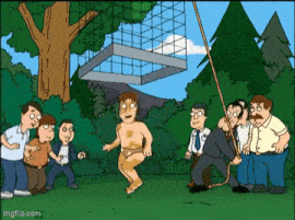 a group of men are standing around a man in a bathing suit .