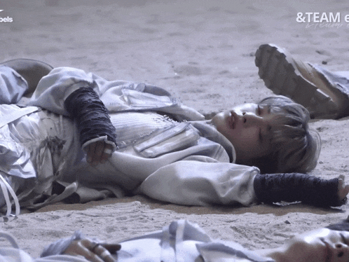 a person laying on the ground with the words & team written above them