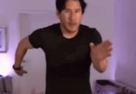 a man in a black shirt is running in a room with purple lights .