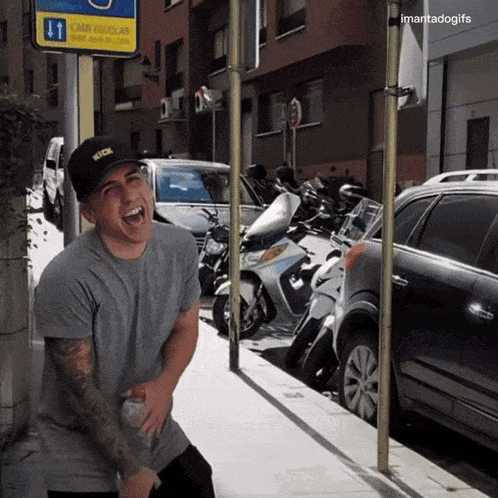 a man wearing a hat that says kick is laughing
