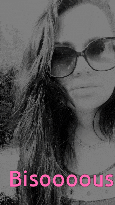 a black and white photo of a woman wearing sunglasses with bisooous written on the bottom