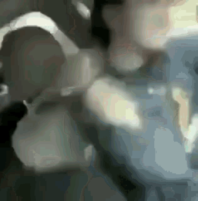 a blurry picture of a man sitting in a car .