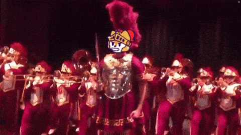 a man in a roman armor stands in front of a band
