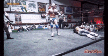 a man in a wrestling ring with the words #wrestlerave wrestling on the bottom