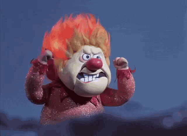 a cartoon character with red hair and a red nose is making a funny face .