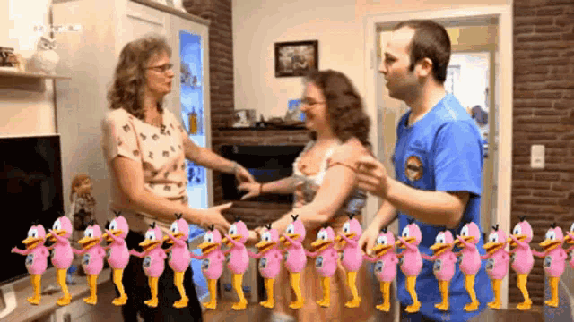 a man in a blue shirt is dancing with a woman in a pink duck outfit
