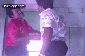 two men are shaking hands in a room in a movie .