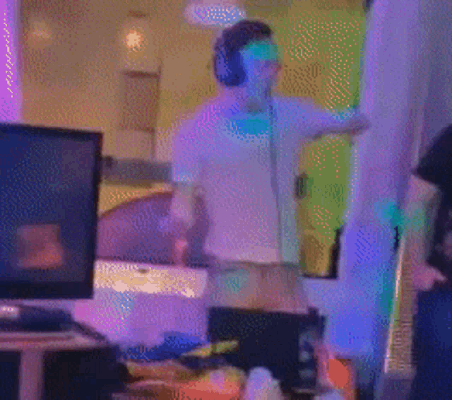 a blurry picture of a man dancing in a room with a lot of lights