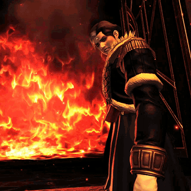 a man is standing in front of a large fire
