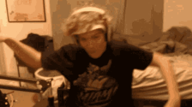 a man wearing a miami shirt is dancing in a room .