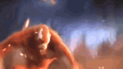 a blurry picture of a person 's face with a blue sky in the background
