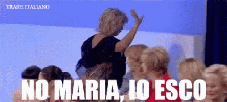 a woman stands in front of a crowd with the words no maria io esco written on the bottom