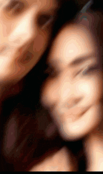 a blurry picture of a man and a woman taking a selfie together .