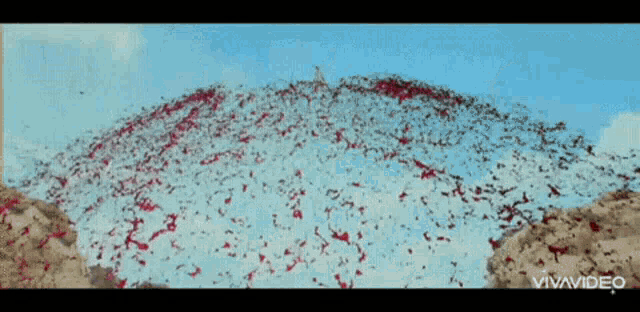 a bunch of red and white confetti is flying in the air