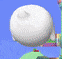 a white ball is sitting on top of a green circle .